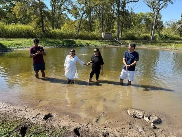 Organizers standing in the pond during a site walkthrough
